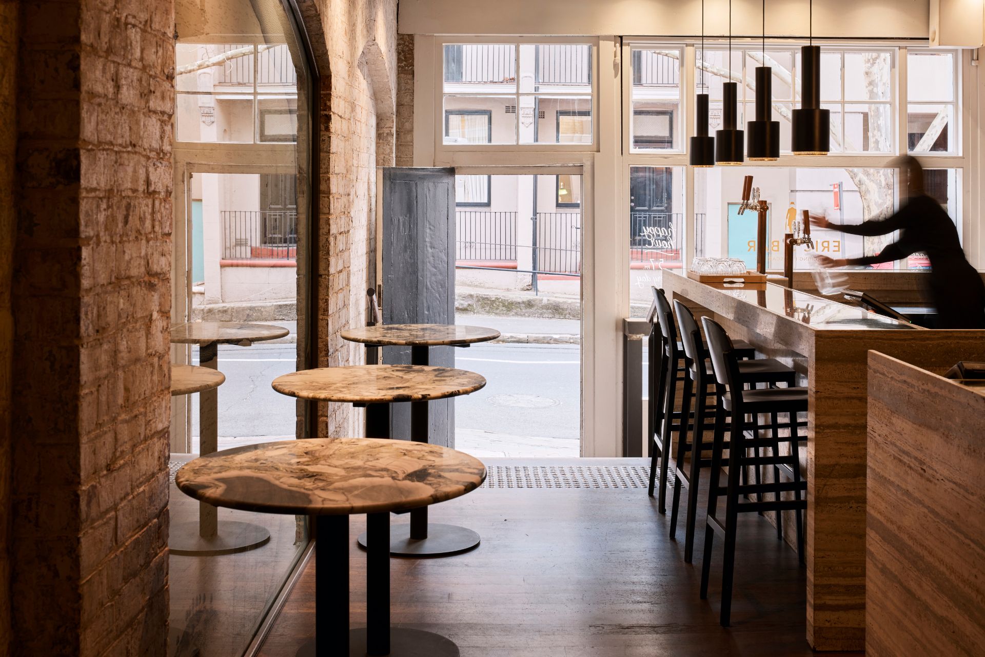 Eric's Bar interior with sandstone walls, bar seating, and Harrington Street beyond the windows